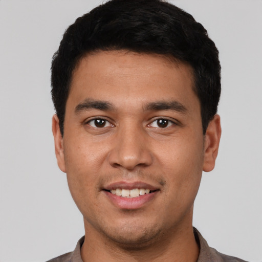 Joyful white young-adult male with short  black hair and brown eyes