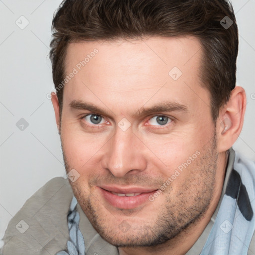 Joyful white adult male with short  brown hair and brown eyes