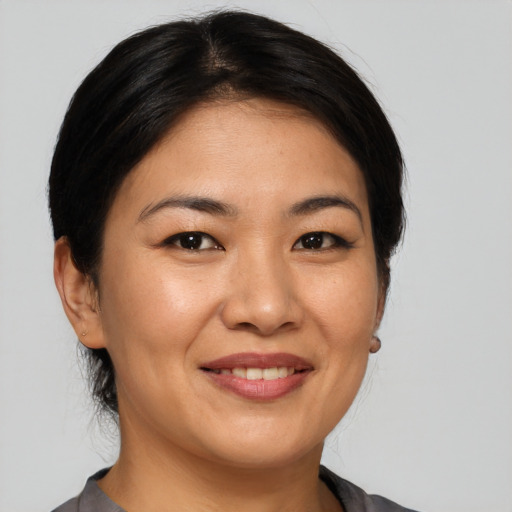 Joyful asian young-adult female with medium  black hair and brown eyes