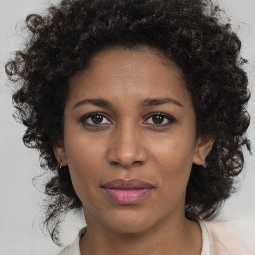 Joyful black young-adult female with medium  brown hair and brown eyes