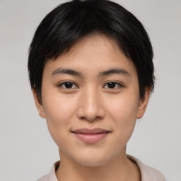 Joyful asian young-adult female with short  black hair and brown eyes