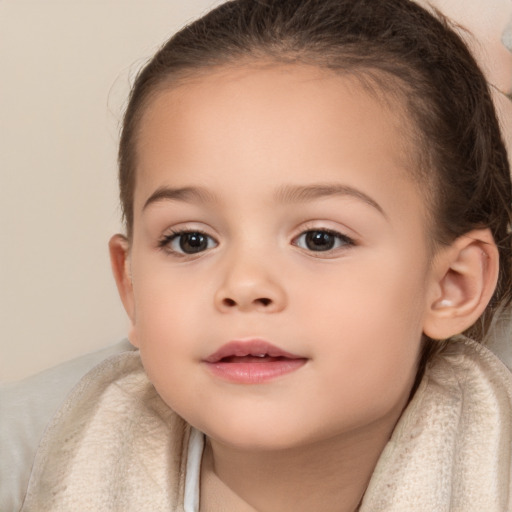 Joyful white child female with medium  brown hair and brown eyes