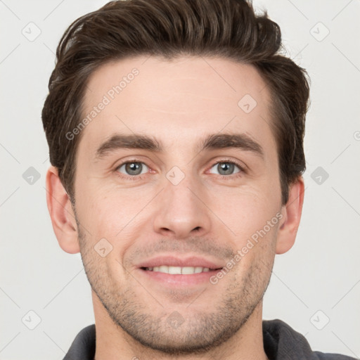 Joyful white young-adult male with short  brown hair and grey eyes