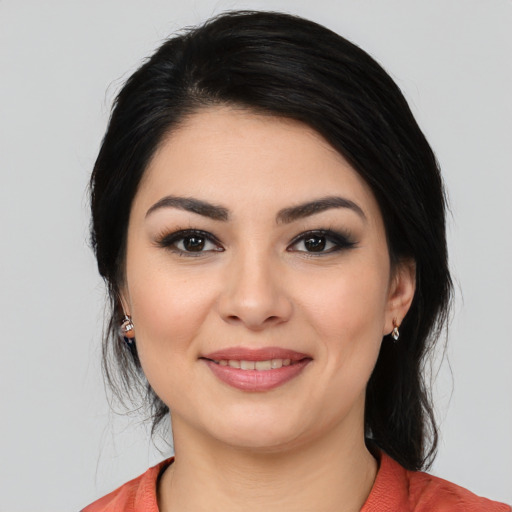 Joyful latino young-adult female with medium  black hair and brown eyes