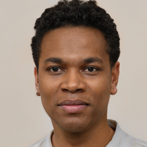 Joyful black young-adult male with short  black hair and brown eyes