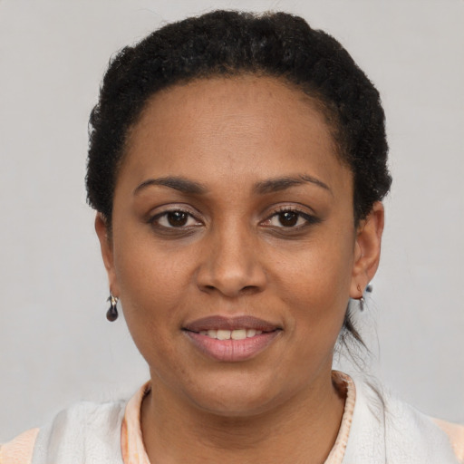 Joyful latino young-adult female with short  black hair and brown eyes