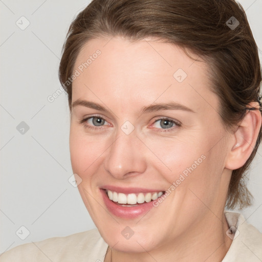 Joyful white young-adult female with medium  brown hair and grey eyes