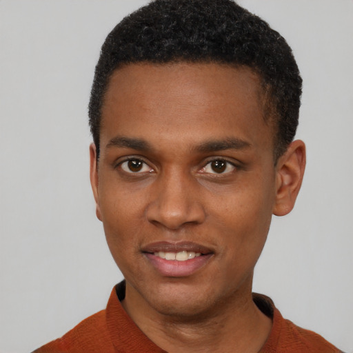 Joyful black young-adult male with short  brown hair and brown eyes