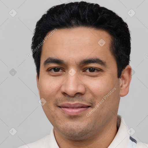 Joyful latino young-adult male with short  black hair and brown eyes