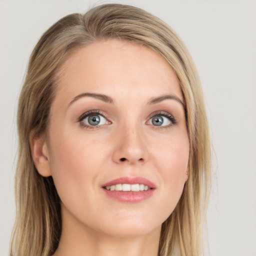 Joyful white young-adult female with long  brown hair and blue eyes