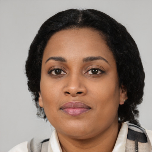 Joyful black young-adult female with medium  black hair and brown eyes