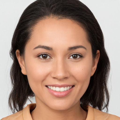 Joyful white young-adult female with medium  brown hair and brown eyes