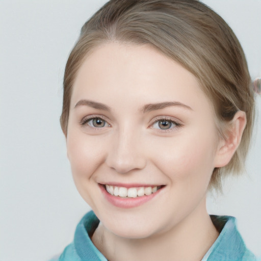 Joyful white young-adult female with medium  brown hair and blue eyes