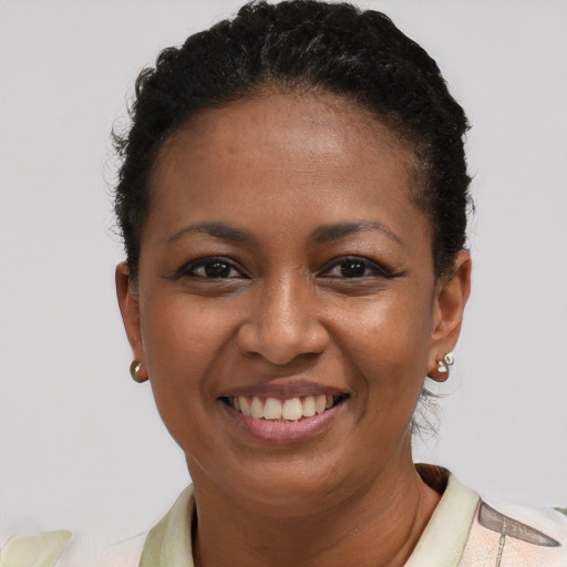Joyful black young-adult female with short  brown hair and brown eyes