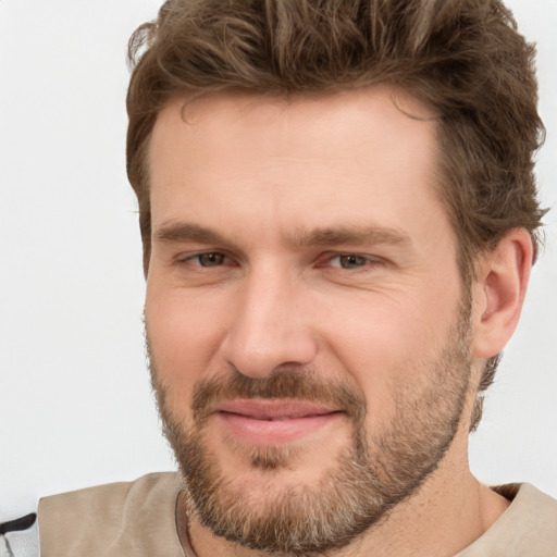 Joyful white adult male with short  brown hair and brown eyes