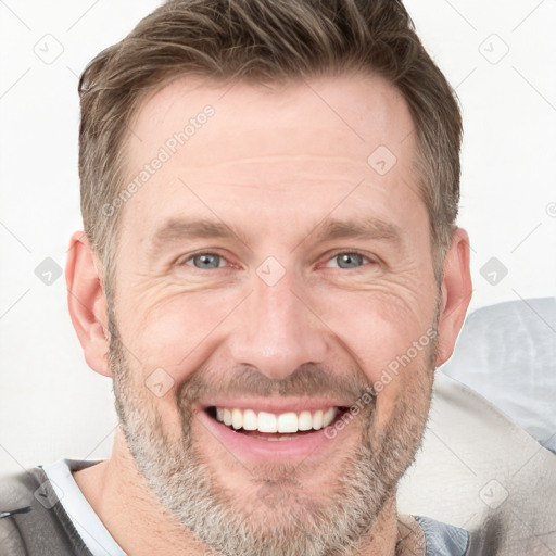 Joyful white adult male with short  brown hair and grey eyes