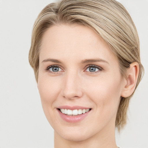 Joyful white young-adult female with medium  brown hair and green eyes