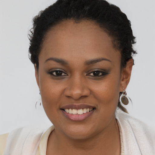 Joyful black young-adult female with short  brown hair and brown eyes