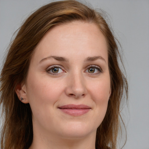 Joyful white young-adult female with long  brown hair and blue eyes