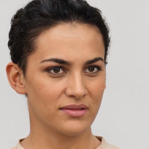 Joyful latino young-adult female with short  brown hair and brown eyes