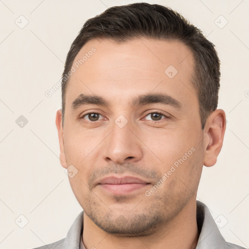 Joyful white young-adult male with short  brown hair and brown eyes