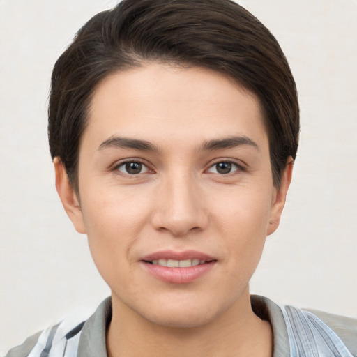 Joyful white young-adult female with short  brown hair and brown eyes