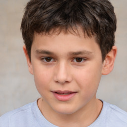 Joyful white child male with short  brown hair and brown eyes