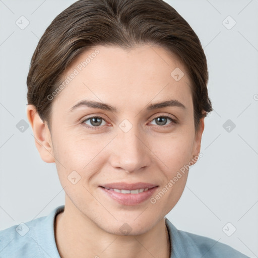 Joyful white young-adult female with short  brown hair and grey eyes