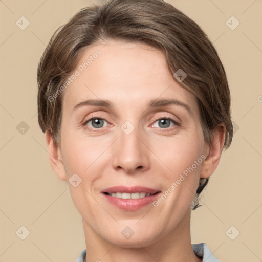 Joyful white adult female with short  brown hair and grey eyes