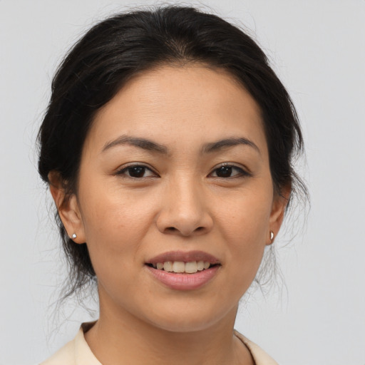 Joyful asian young-adult female with medium  brown hair and brown eyes