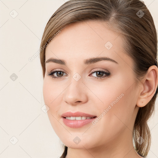 Joyful white young-adult female with long  brown hair and brown eyes