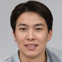 Joyful asian young-adult male with short  brown hair and brown eyes