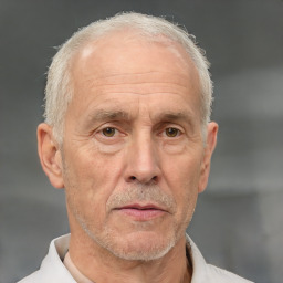 Neutral white middle-aged male with short  gray hair and brown eyes