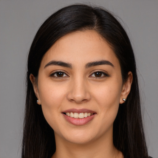 Joyful latino young-adult female with long  brown hair and brown eyes