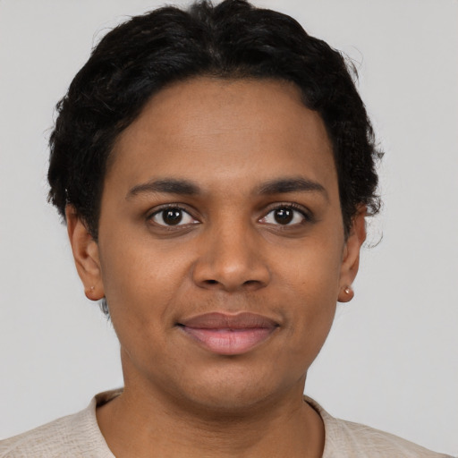 Joyful black young-adult female with short  brown hair and brown eyes