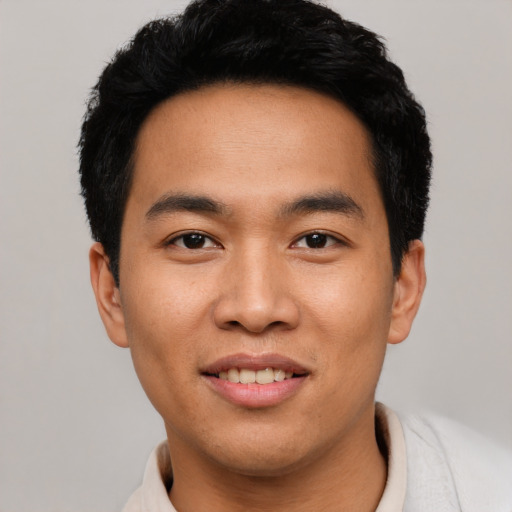 Joyful asian young-adult male with short  black hair and brown eyes