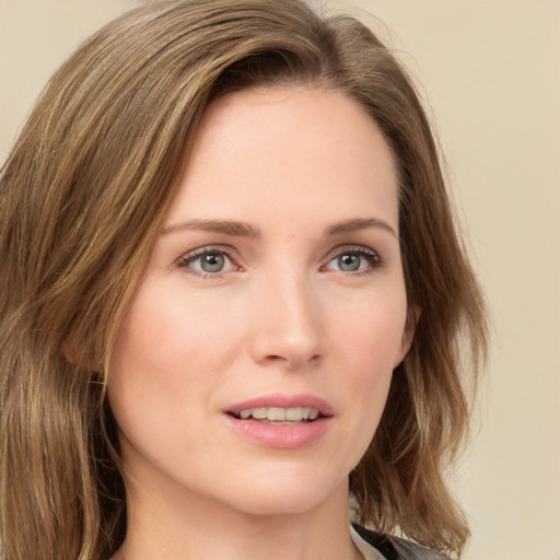 Joyful white young-adult female with medium  brown hair and green eyes