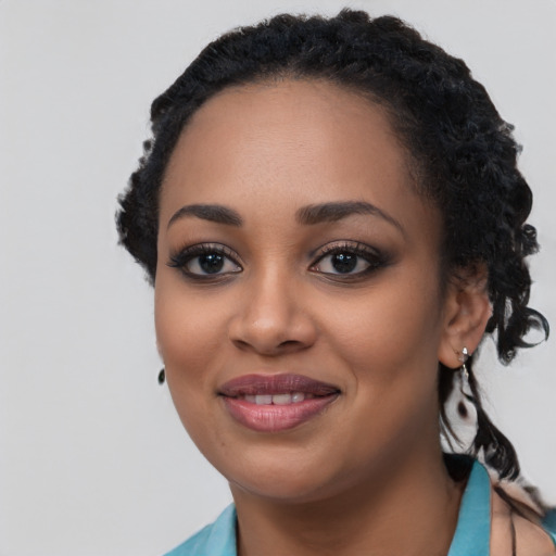 Joyful black young-adult female with short  black hair and brown eyes