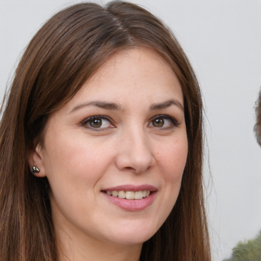 Joyful white young-adult female with long  brown hair and brown eyes