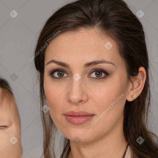 Joyful white young-adult female with long  brown hair and brown eyes