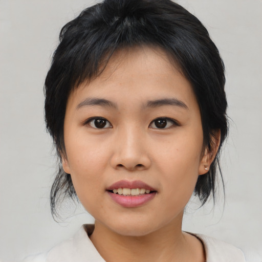 Joyful asian young-adult female with medium  black hair and brown eyes