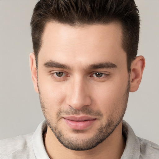 Joyful white young-adult male with short  brown hair and brown eyes