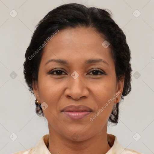 Joyful latino adult female with medium  brown hair and brown eyes