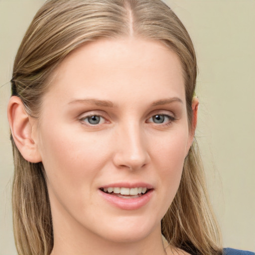 Joyful white young-adult female with long  brown hair and blue eyes