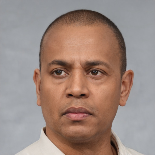 Neutral latino adult male with short  brown hair and brown eyes
