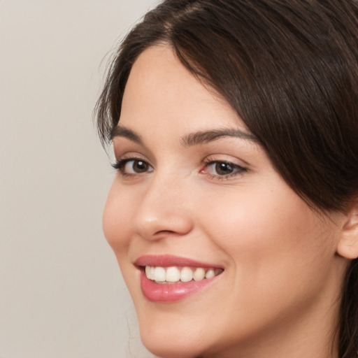 Joyful white young-adult female with medium  brown hair and brown eyes