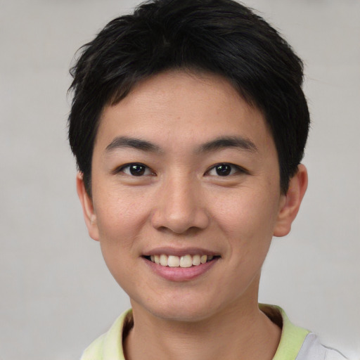 Joyful asian young-adult male with short  black hair and brown eyes