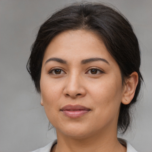 Joyful latino young-adult female with medium  brown hair and brown eyes