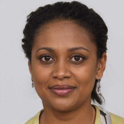 Joyful black young-adult female with short  brown hair and brown eyes