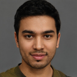 Joyful latino young-adult male with short  brown hair and brown eyes